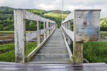 The Jubilee Bridge close to castle Stalker in Appin with breathtaking view of mountains in the background