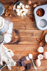 Baking background. Cooking ingredients for dough and wooden board on white rustic wood. Top view with copy space, recipe or culinary classes.