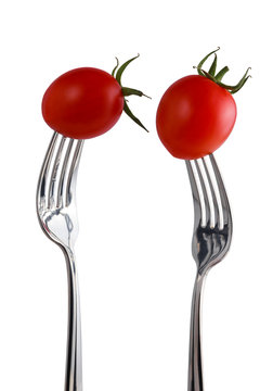 Tomato on a fork isolated on white © pbnew