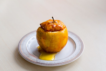 Baked Apple drizzled with honey. The concept of a healthy diet without sugar and flour. Home recipe.