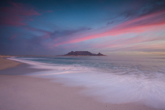 Beautiful wide angle landscape image of Table Mountain in Cape Town South Africa as seen from Blouberg beach