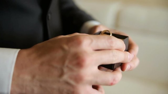The man corrects the rings in a box
