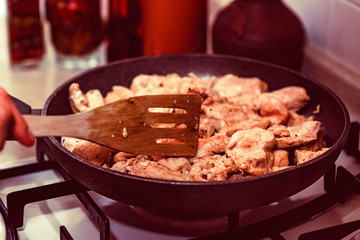 Cooking chicken fillet on frying pan