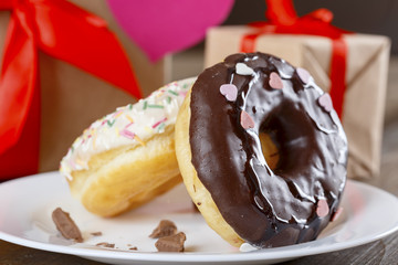 Donuts for St.Valentine's Day on the background of gifts