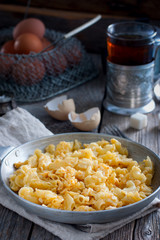 Pasta cooked with egg in a frying pan, rustic style, selective focus