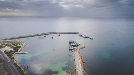 Aerial views over Gansbaai harbor in the overberg in the Western Cape of South Africa With fishing...