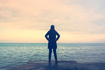 proud woman at the sea, lonely lady looking the horizon in winter season