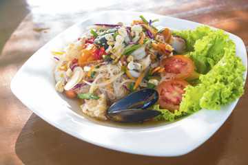 Yummy Vermicelli with spicy mixed seafood on White Square Plate.