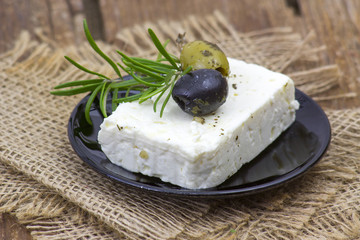 feta cheese and olives with herbs in olive oil