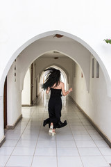 back view of young woman running at corridor