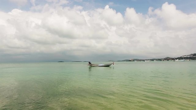 a small boat in the calm clear sea of ​​Thailand
