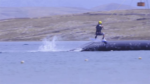 Tracking wakeboarder making stunts on sea 4K