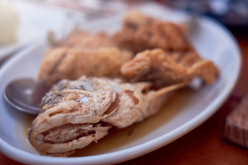 Fish head was fried crispy and delicious. subject is blurred.
