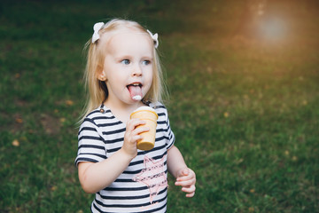 Little girl eating delicious ice cream