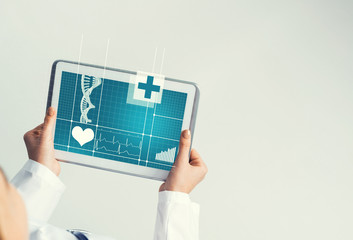 Close of female doctor hands working with tablet pc computer