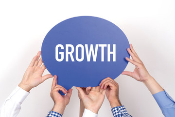 Group of people holding the GROWTH written speech bubble