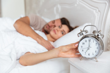 Side view of Smiling Lovely couple sleeping together in bed