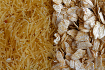The texture of oatmeal separated with pasta. The concept of proper nutrition and healthy lifestyle. Top view, close-up as background or texture