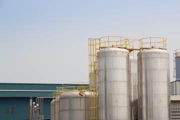stainless steel silos with yellow ladder