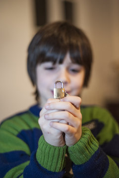 10 Year Old Child Portrait Showing A Small Padlock In Hands