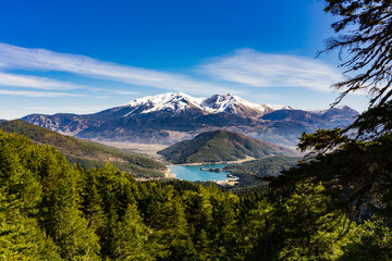Panoramic view of Doxa lake and the snow covered Ziria mountain in Peloponnese Greece