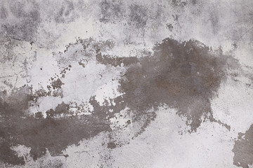 Old concrete wall with cracks. Aged cracked plaster wall background and texture style. Design on cement