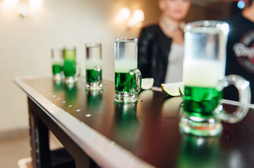 preparing green mexican cocktail drink at the bar