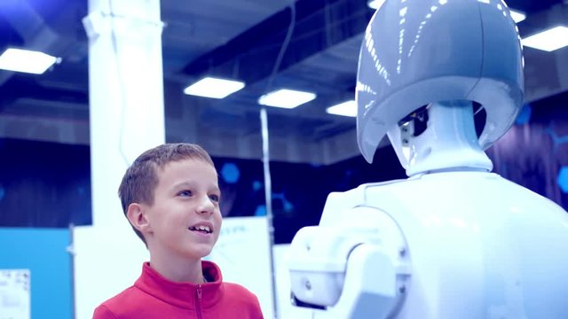 boy communicates with an interactive robot