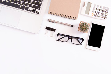 White office desk table, workspace office with laptop, smartphone black screen,pen,calculator, glasses, Top view with copy space