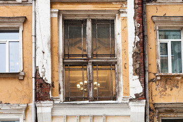 shabby window of old urban house in Moscow