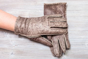 female hand in new hand-made glove on table