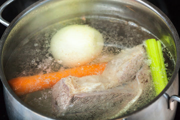 boiling beef broth in stew pan close up