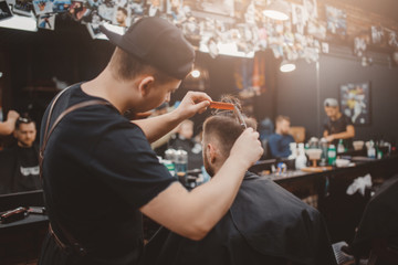 Barber shop. Barber Master does hairdo Barbershop