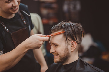 Barber shop. Barber master hairdresser does hairstyle. Concept Barbershop.