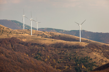 Wind turbines in the mountain, at a sunny autumn day