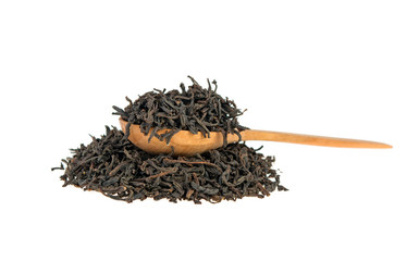 black tea on a wooden spoon with a slide isolated on a white background