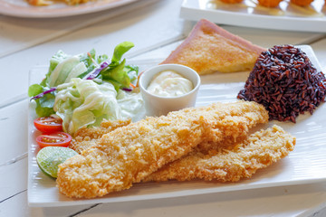 fish steak with rice on  white dish