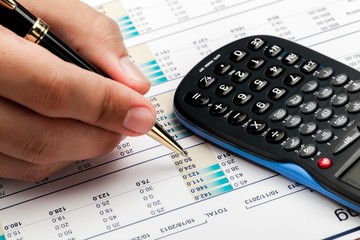 Close-up of a Businessman Analyzing Financial Figures with