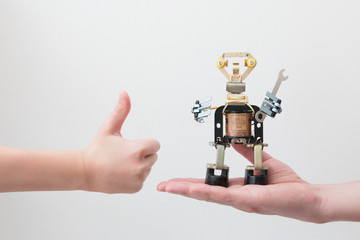 STEM education. Metal robot made by hands in a class in chemistry and robotics on the hand of student. Code th robot. Background. Free bots. Technology. Mathematics. Science.