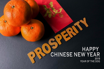 Word of PROSPERITY ,ang pow or red packets and mandarin oranges, golden Chinese letter means luck