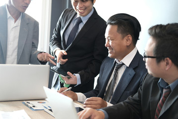 business adviser analyzing company financial report. professional investor discussing balance sheet statement. businessman working on startup project with co working team. business meeting at office.