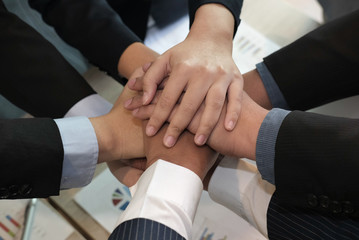 businessman joining hand, business team touching hands together - unity, harmony, teamwork, partnership, collaboration, corporate concept.