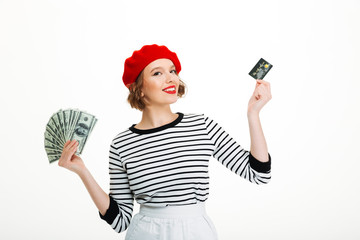 Happy young lady holding money dollars and credit card