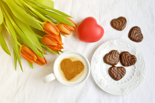 Cappuccino with Heart Pattern of Cinnamon and Flowers Composition Tulips White Background Valentines Day Spring Concept