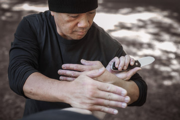 Lameco Astig Combatives instructor demonstrates knife attack disarming technique