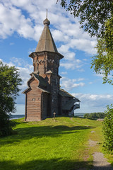Old wooden Dormition Church of Kondopoga on the shores of Lake Onega in sunny summer day, Karelia, Russia