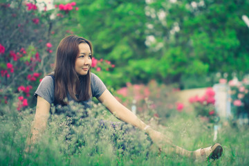 Beautiful woman sitting in a meadow.