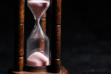 Hourglass on black background. 