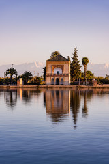 Obraz premium Menara Gardens Pavilion reflect in water at sunset,Morocco