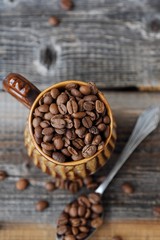 Roasted coffee beans in a clay mug 